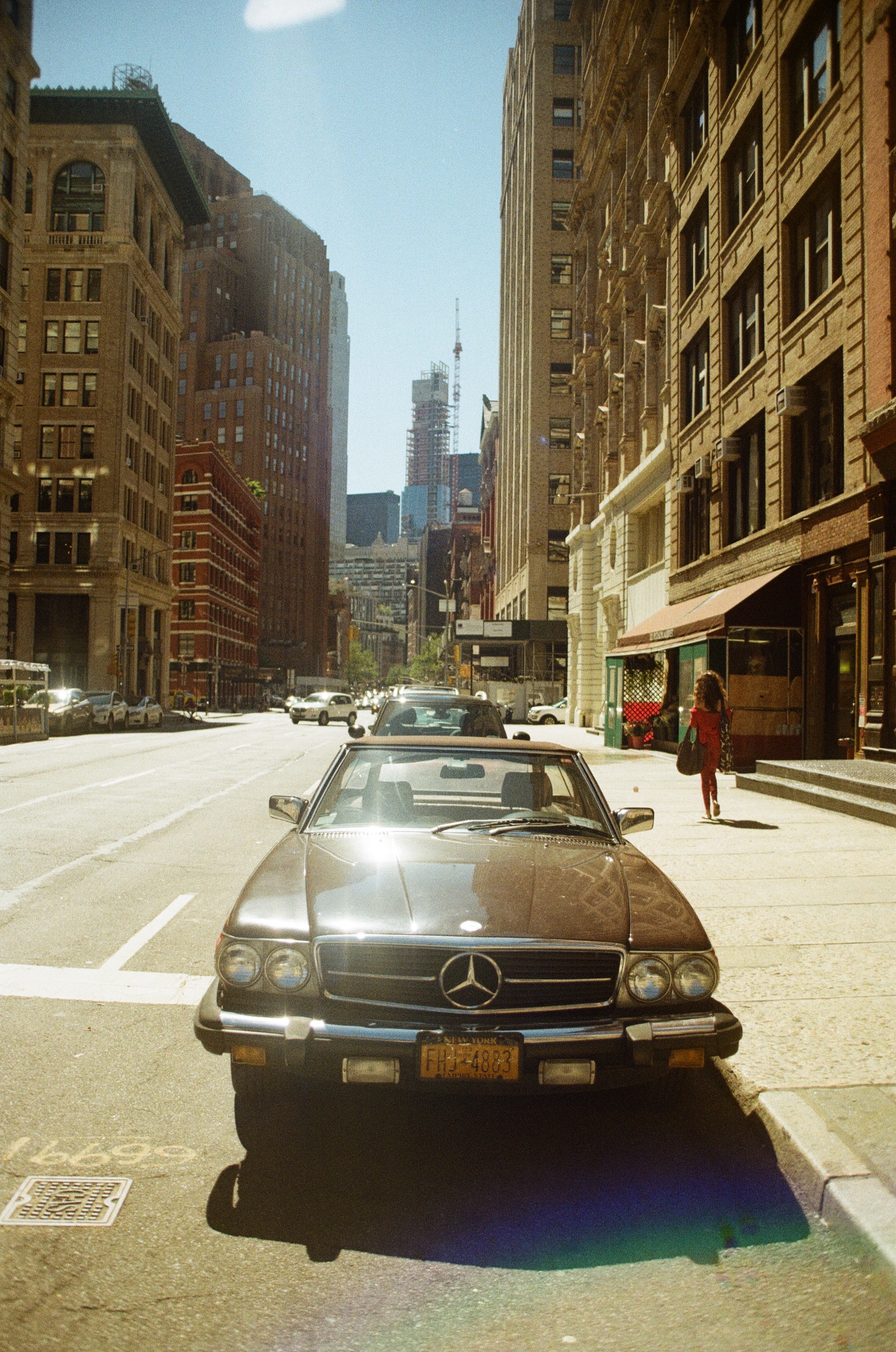vintage mercedes car parked on a street in new york city shot on film