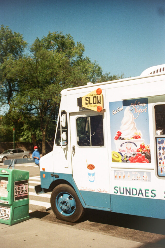 ice cream truck parked on a corner in new york city shot on film